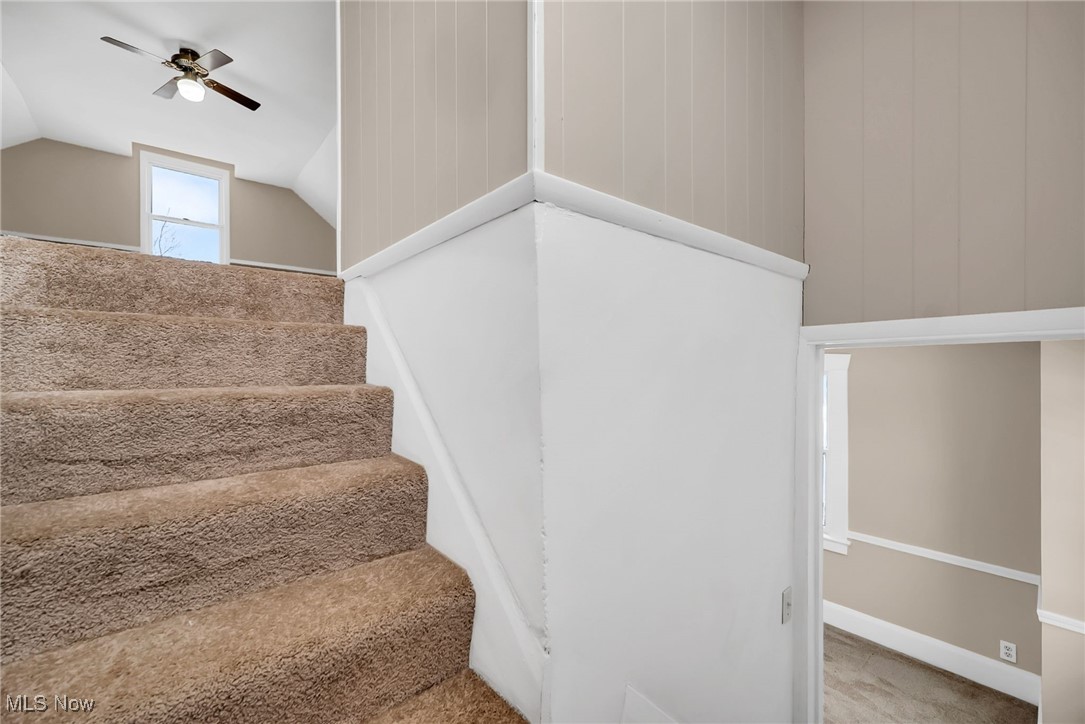 404 Niles Vienna Road Vienna, OH 44473 - Photo 39 of 48 Stairs with carpet floors, vaulted ceiling, and ceiling fan