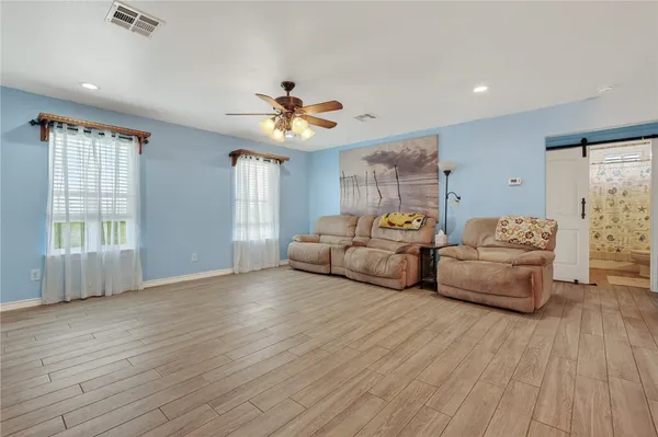 a spacious bedroom with a bed and a couch