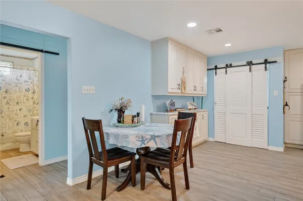a view of a dining room with furniture and wooden floor