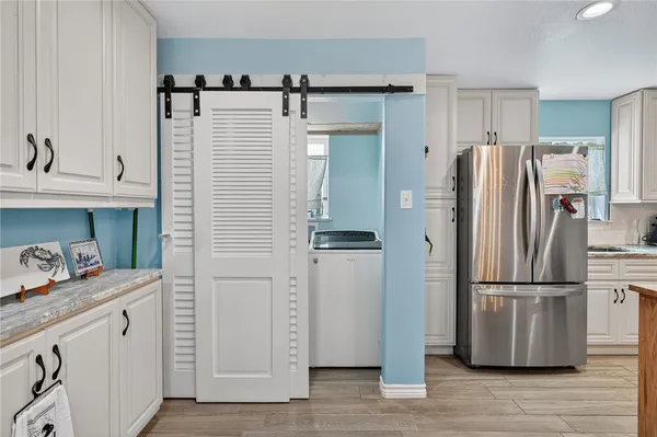 a kitchen with stainless steel appliances a refrigerator and a sink