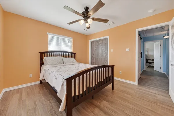 a bedroom with a bed and a chandelier