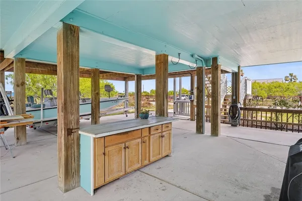 a large kitchen with stainless steel appliances a large window and a view of living room