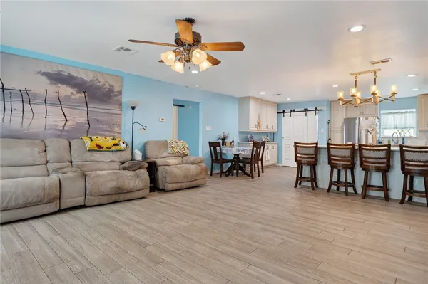 a living room with furniture and kitchen view