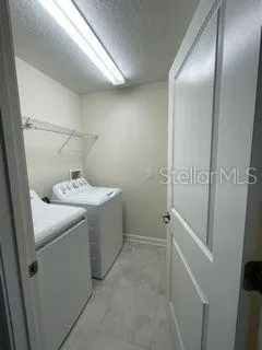 an empty room with windows and cabinet