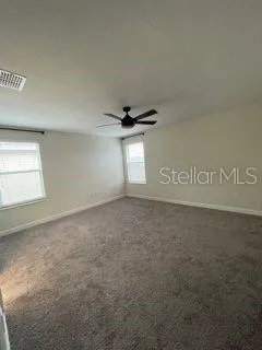 en suite bathroom with a granite countertop sink and a washing machine