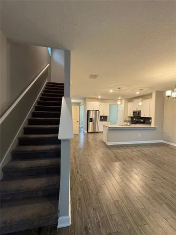a view of kitchen and hall with wooden floor