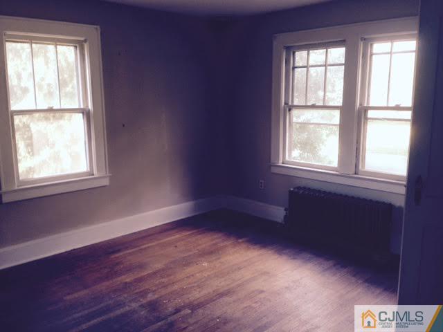 1563 Englishtown Road Old Bridge, NJ 08857 - Photo 2 of 15 an empty room with wooden floor and windows