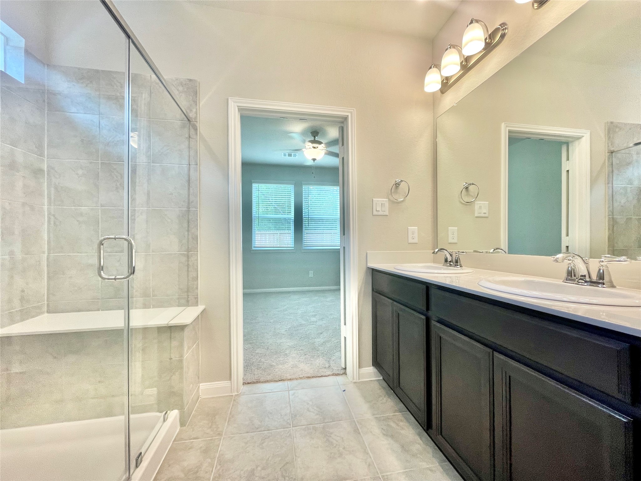 17526 Rosette Grass Conroe, TX 77385 - Photo 18 of 49 a bathroom with a double vanity sink mirror and shower