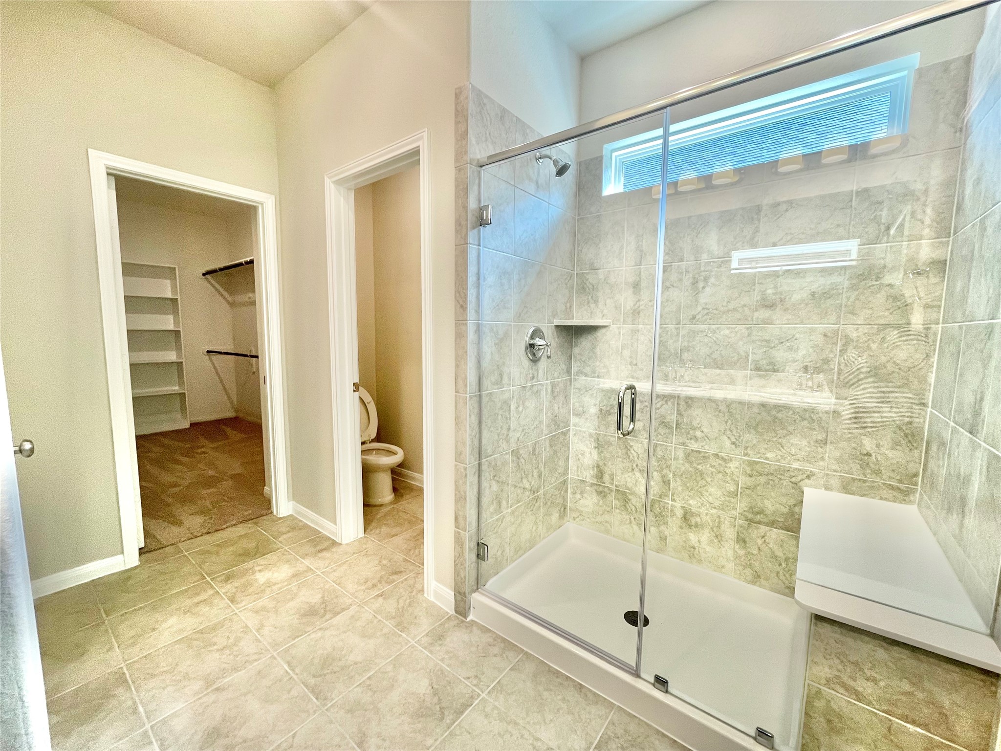 17526 Rosette Grass Conroe, TX 77385 - Photo 19 of 49 a bathroom with a glass shower door and a glass door