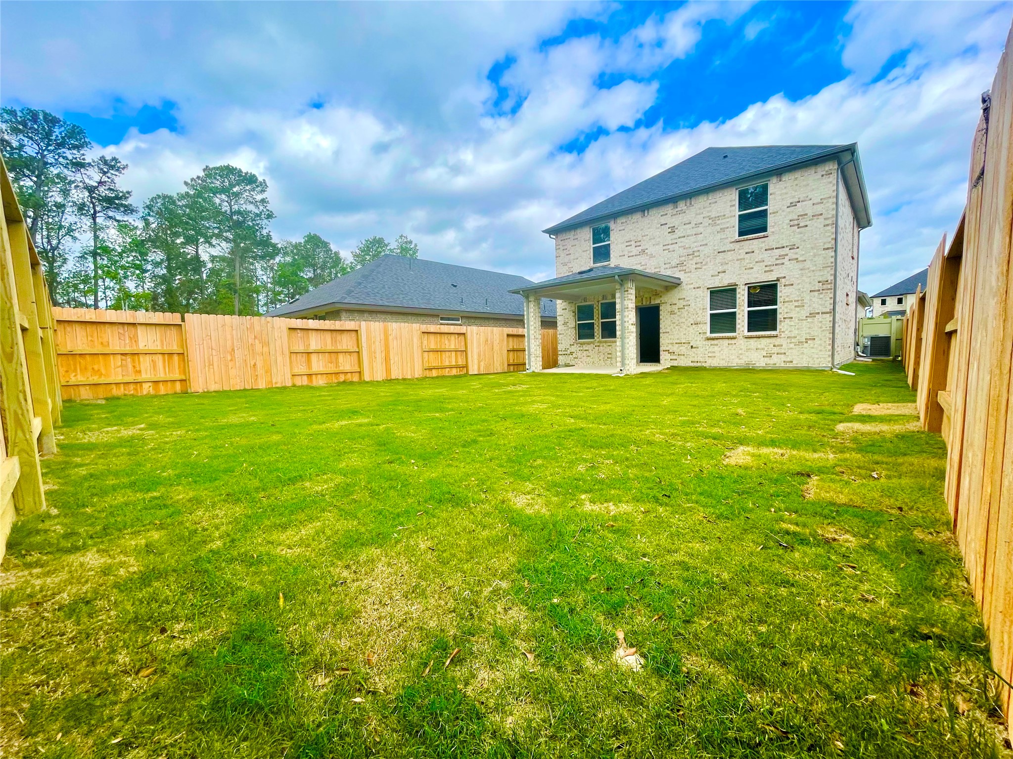 17526 Rosette Grass Conroe, TX 77385 - Photo 25 of 49 a front view of house with yard and seating area