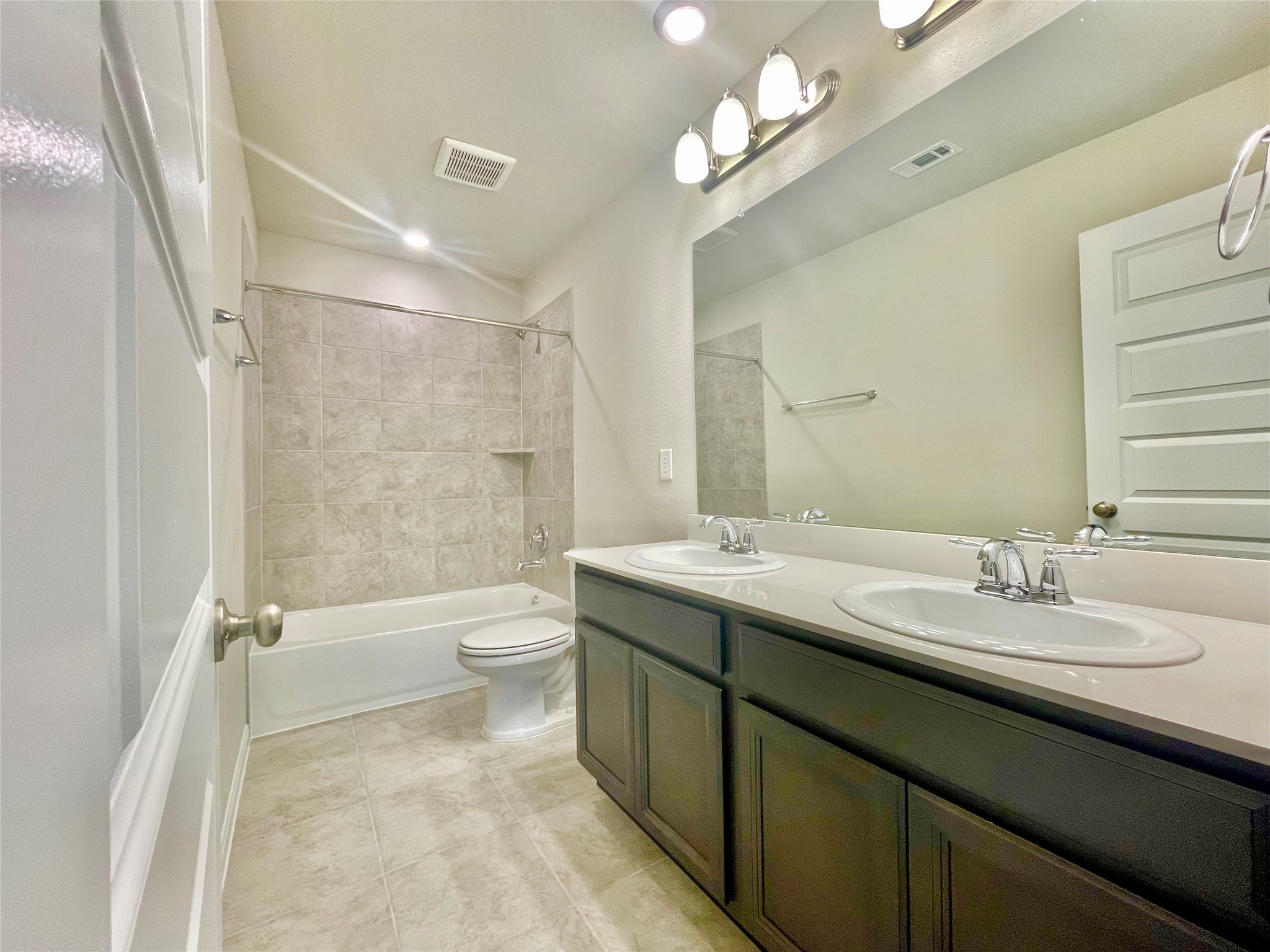 17526 Rosette Grass Conroe, TX 77385 - Photo 30 of 49 a bathroom with a double vanity sink toilet and a mirror