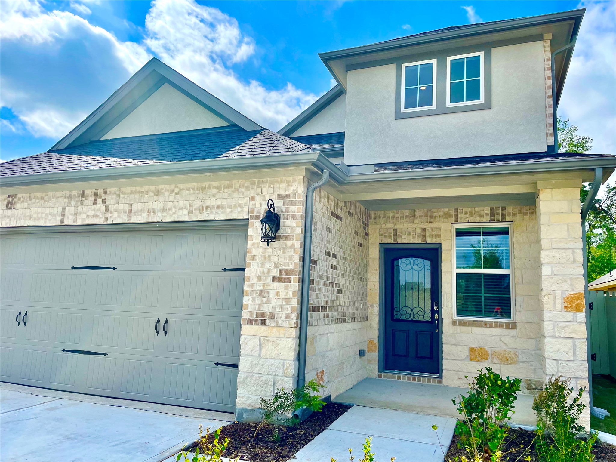17526 Rosette Grass Conroe, TX 77385 - Photo 3 of 49 a front view of a house with a plants