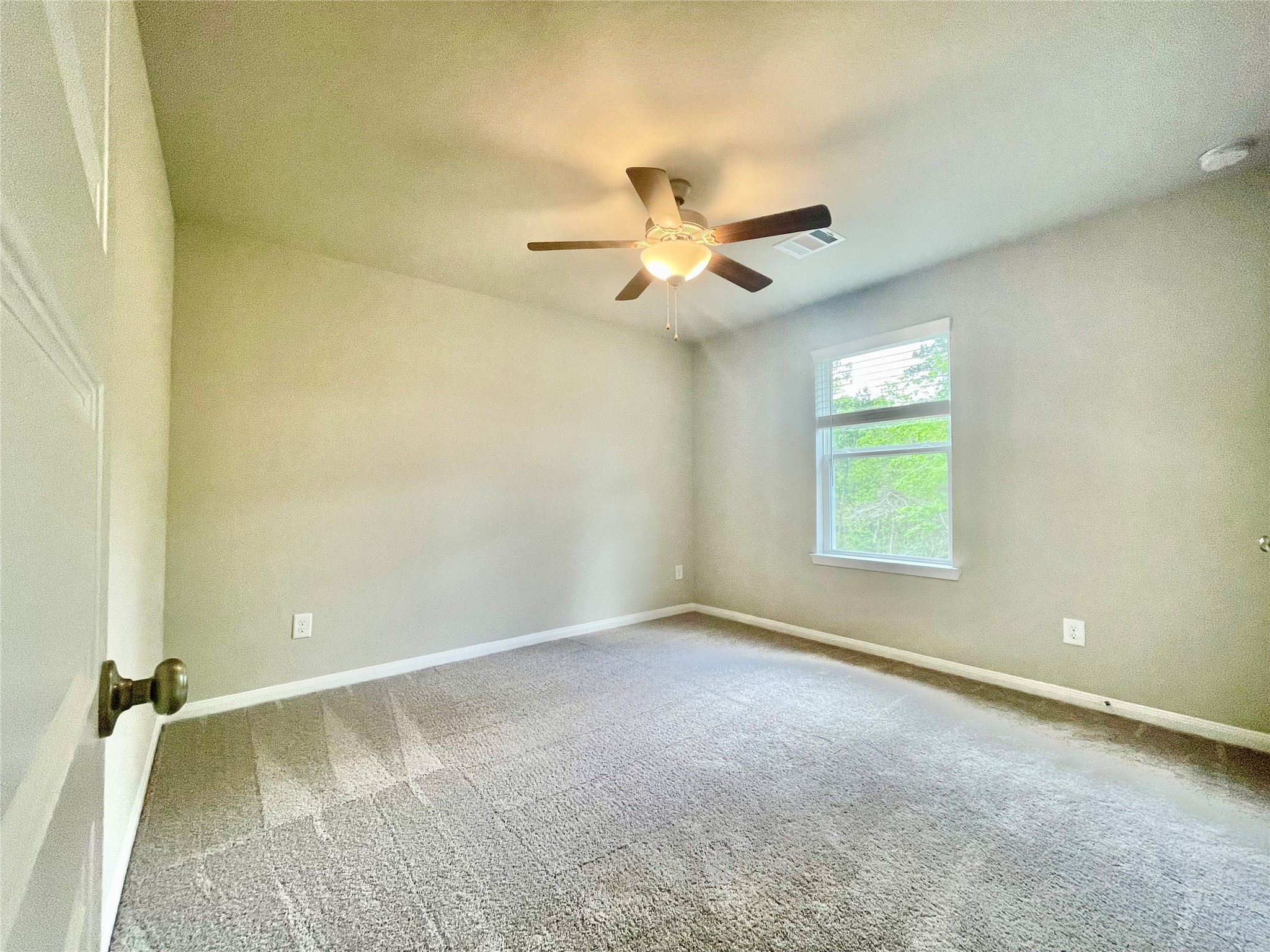 17526 Rosette Grass Conroe, TX 77385 - Photo 32 of 49 an empty room with a window and a fan