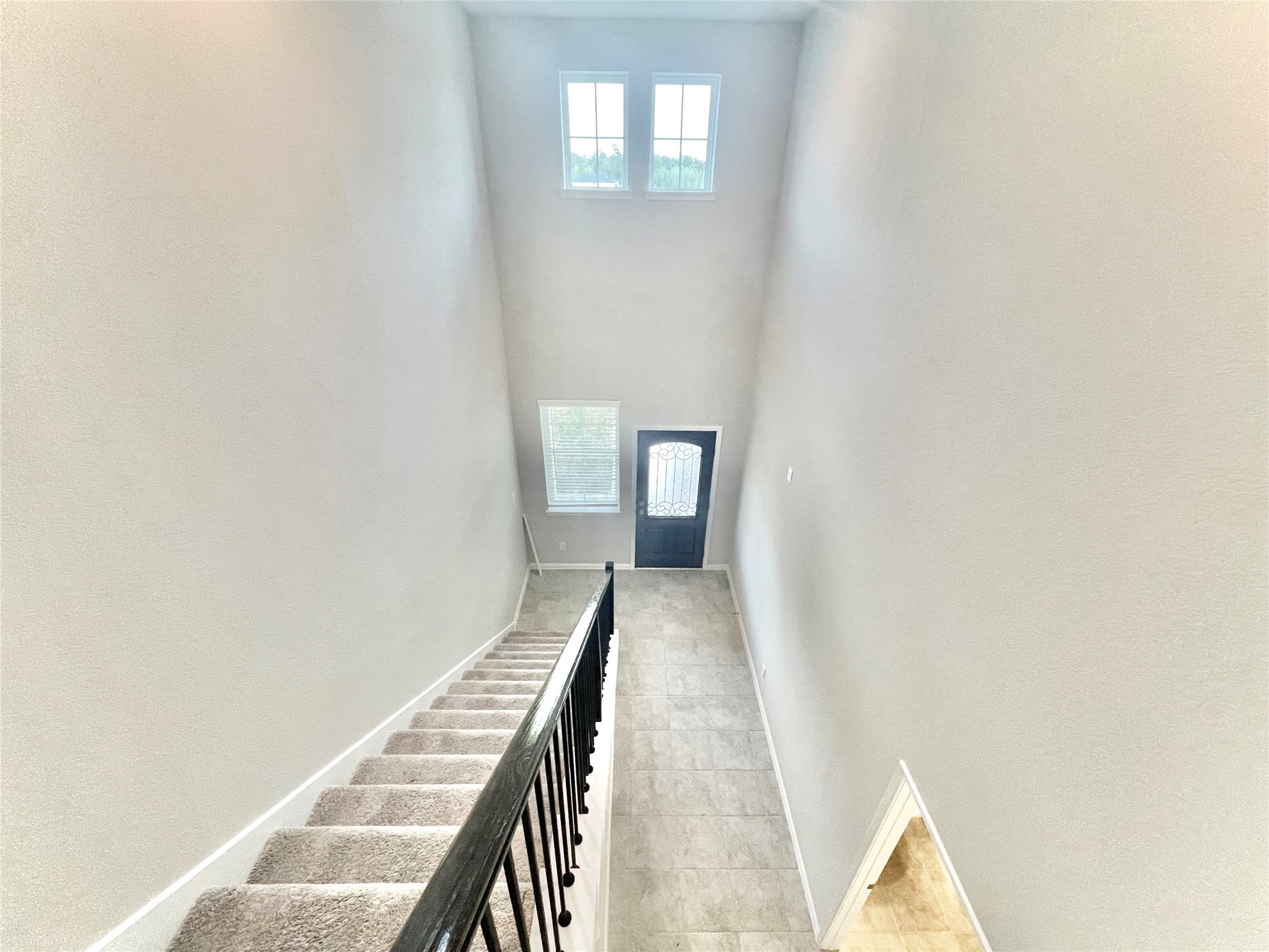 17526 Rosette Grass Conroe, TX 77385 - Photo 38 of 49 a view of a hallway with wooden floor and staircase