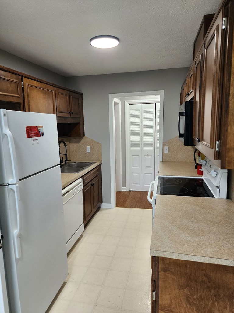 6 Maryland Court, Unit B Columbus, GA 31907 - Photo 11 of 15 a kitchen with a refrigerator sink and stove