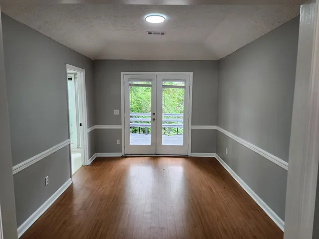 a view of room with window and hardwood floor