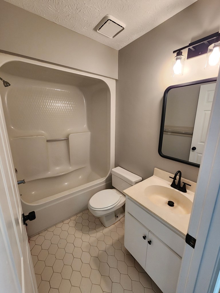6 Maryland Court, Unit B Columbus, GA 31907 - Photo 5 of 15 a bathroom with a sink mirror vanity and toilet