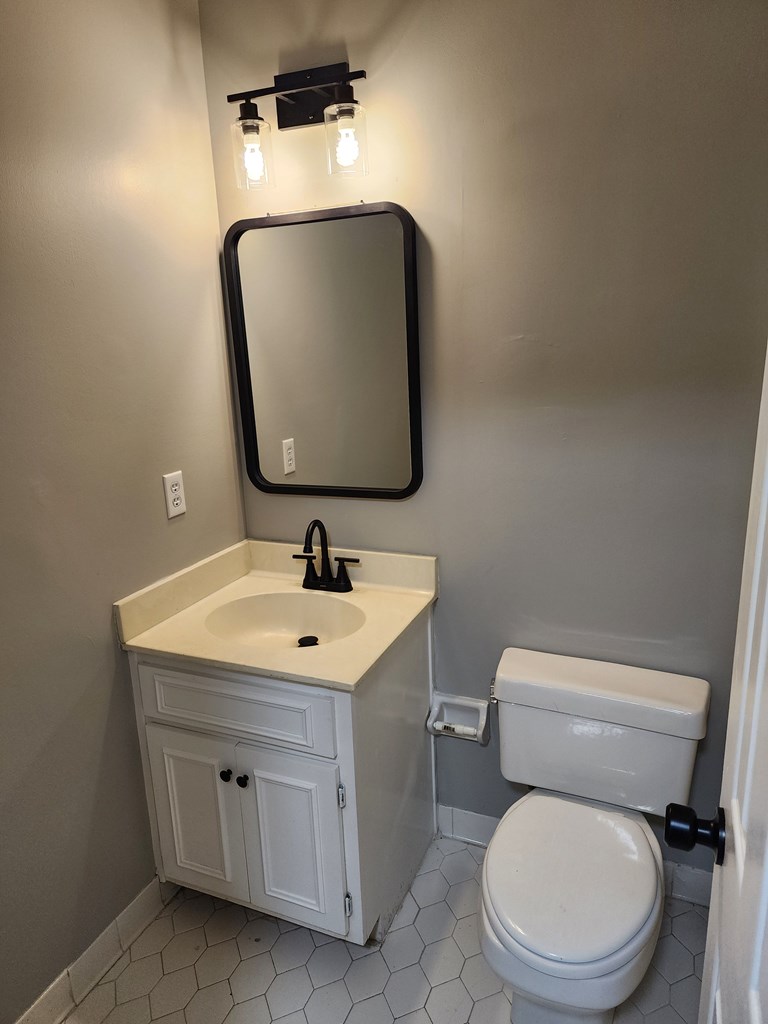 6 Maryland Court, Unit B Columbus, GA 31907 - Photo 7 of 15 a bathroom with a toilet sink and mirror