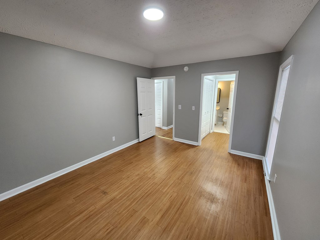 6 Maryland Court, Unit B Columbus, GA 31907 - Photo 9 of 15 wooden floor in an empty room with a window