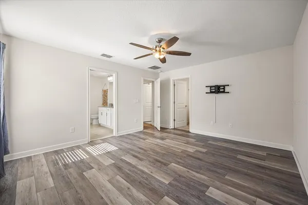 a view of empty room with wooden floor
