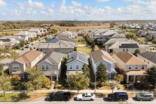an aerial view of a swimming pool with outdoor seating