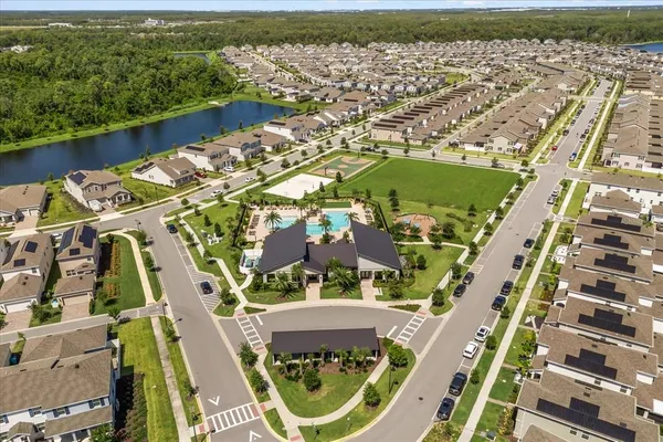 an aerial view of residential houses with outdoor space and swimming pool