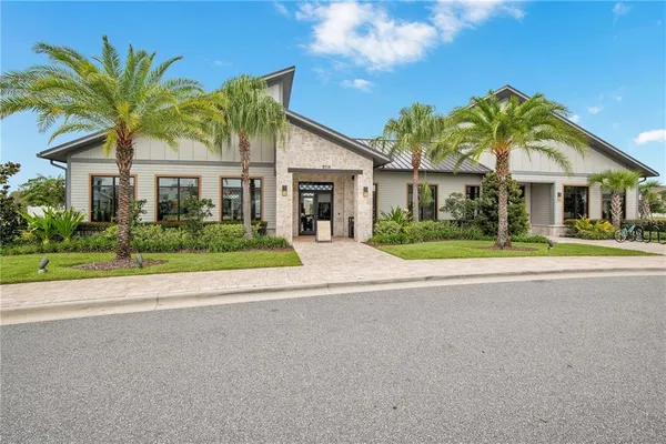 a living room with furniture a chandelier and a dining table