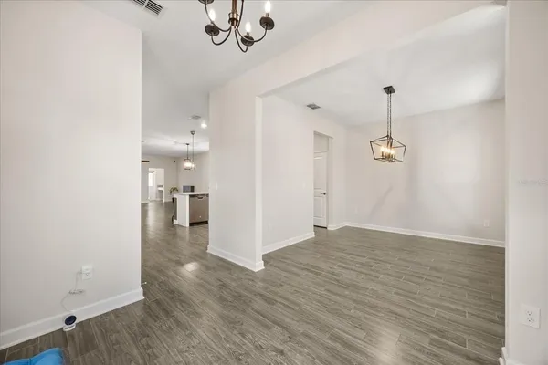 a kitchen with white cabinets and appliances