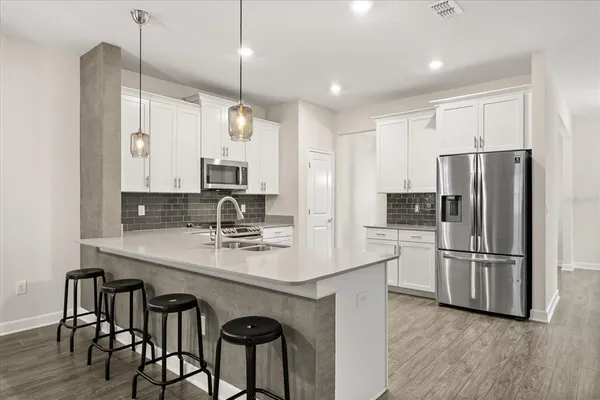 a bathroom with a sink a potted plant and a window