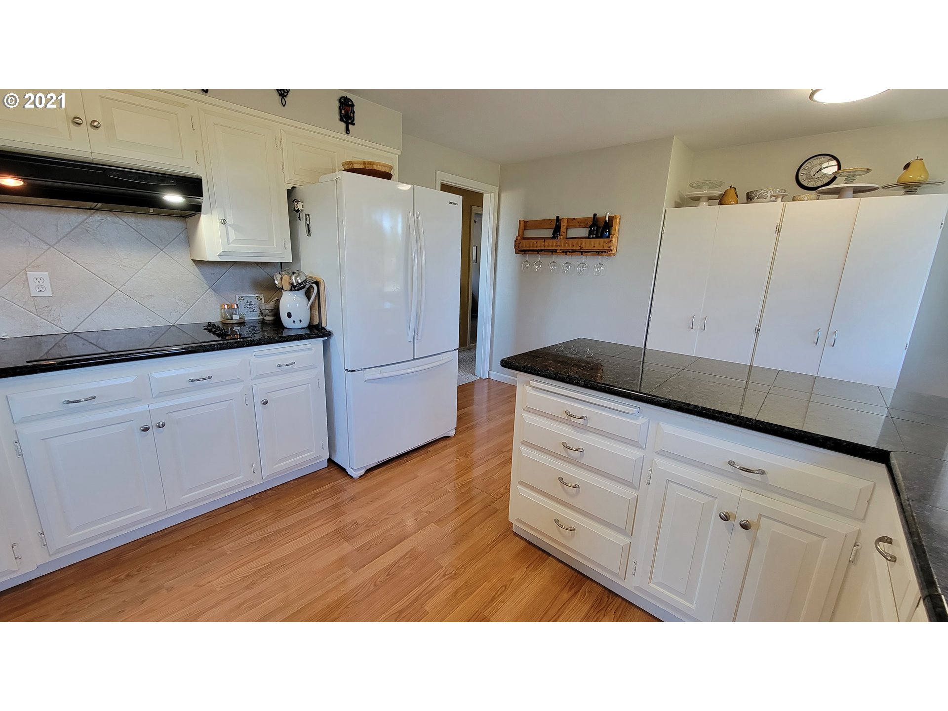 7622 Liberty Road South Salem, OR 97306 - Photo 7 of 32 a kitchen with cabinets and wooden floor