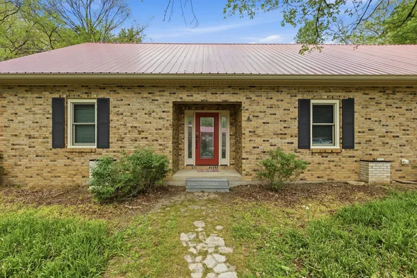 a front view of a house with garden