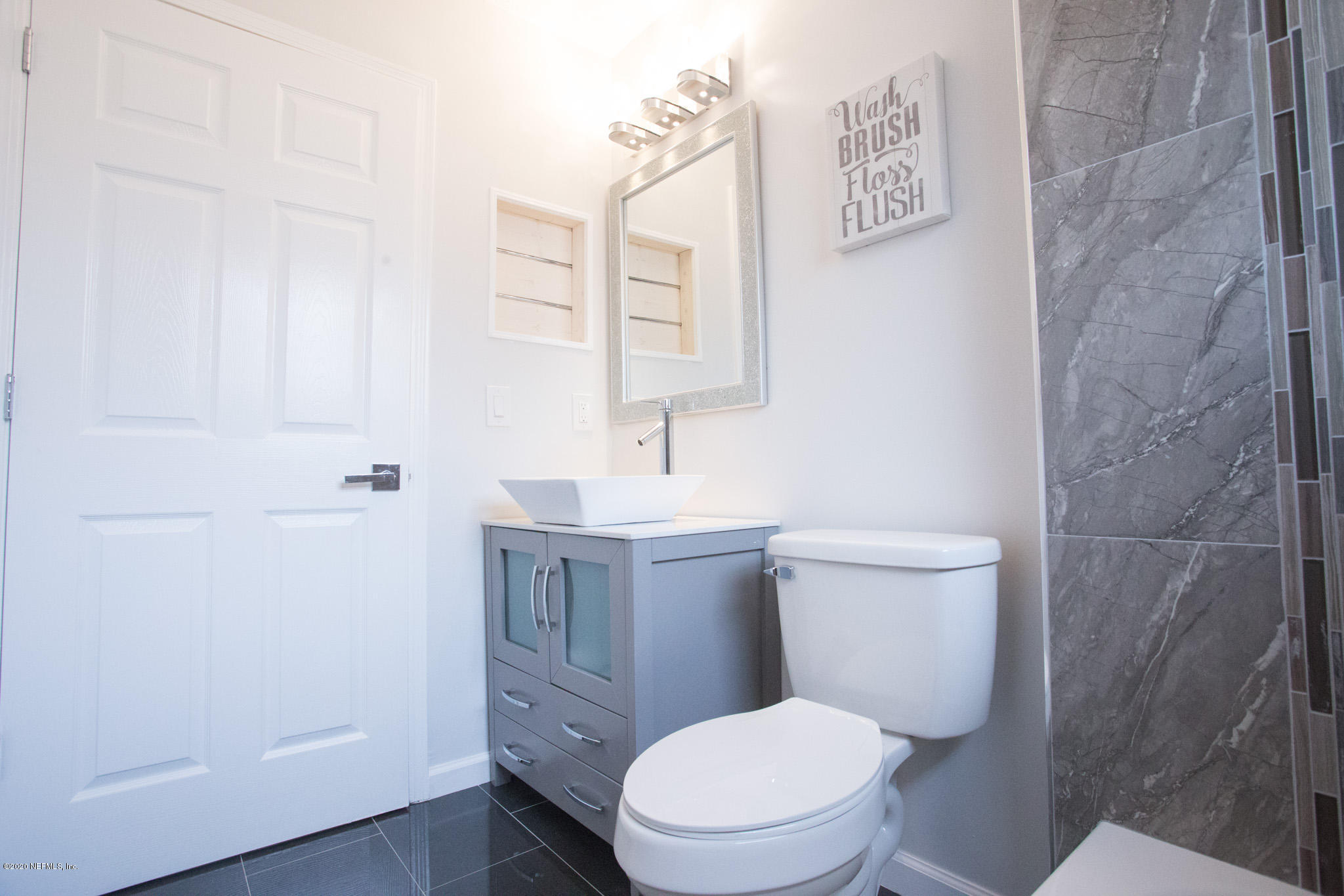 7864 Collins Ridge Boulevard Jacksonville, FL 32244 - Photo 15 of 32 a white toilet sitting next to a bathroom sink