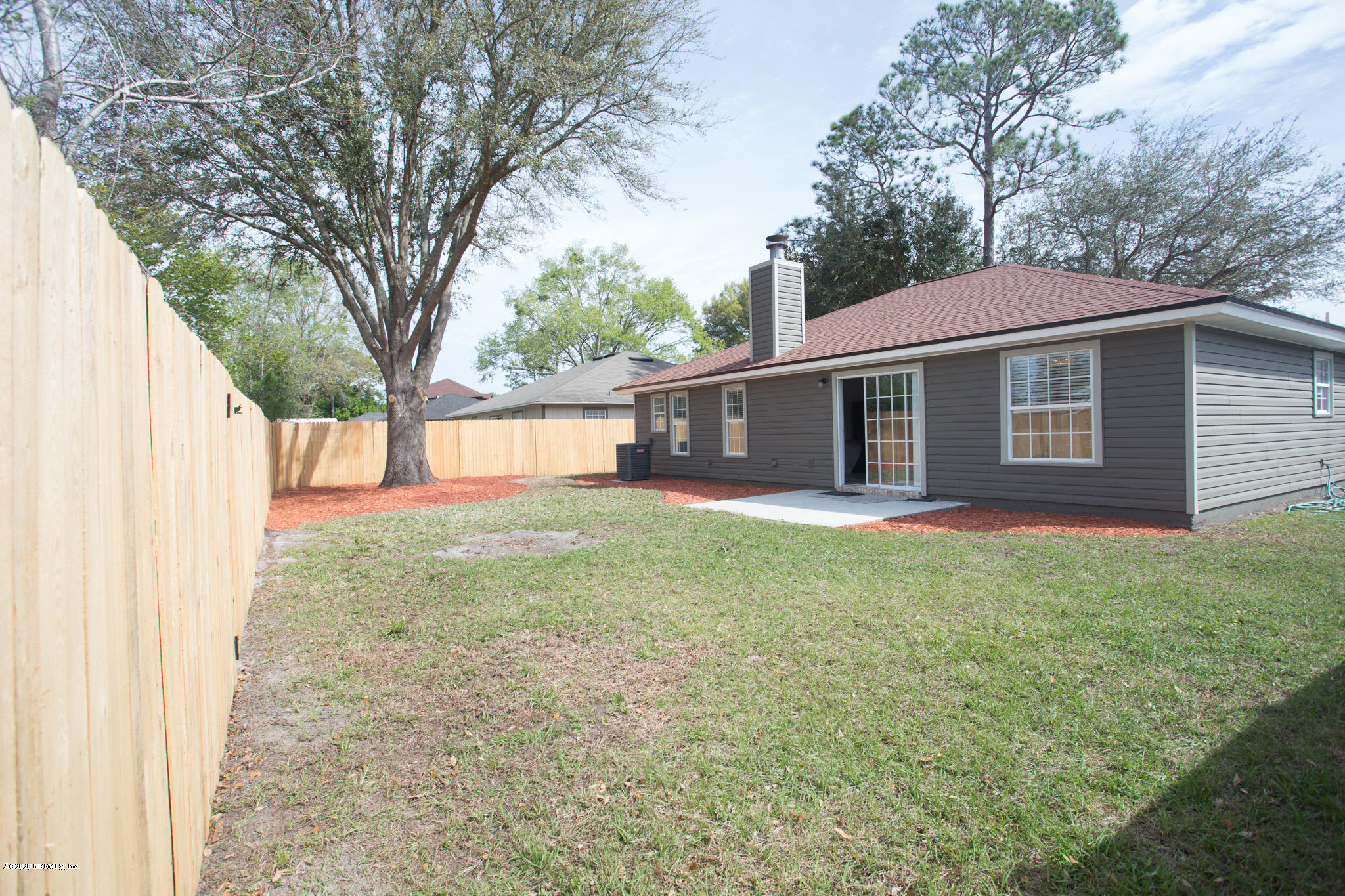 7864 Collins Ridge Boulevard Jacksonville, FL 32244 - Photo 30 of 32 a view of a house with a back yard