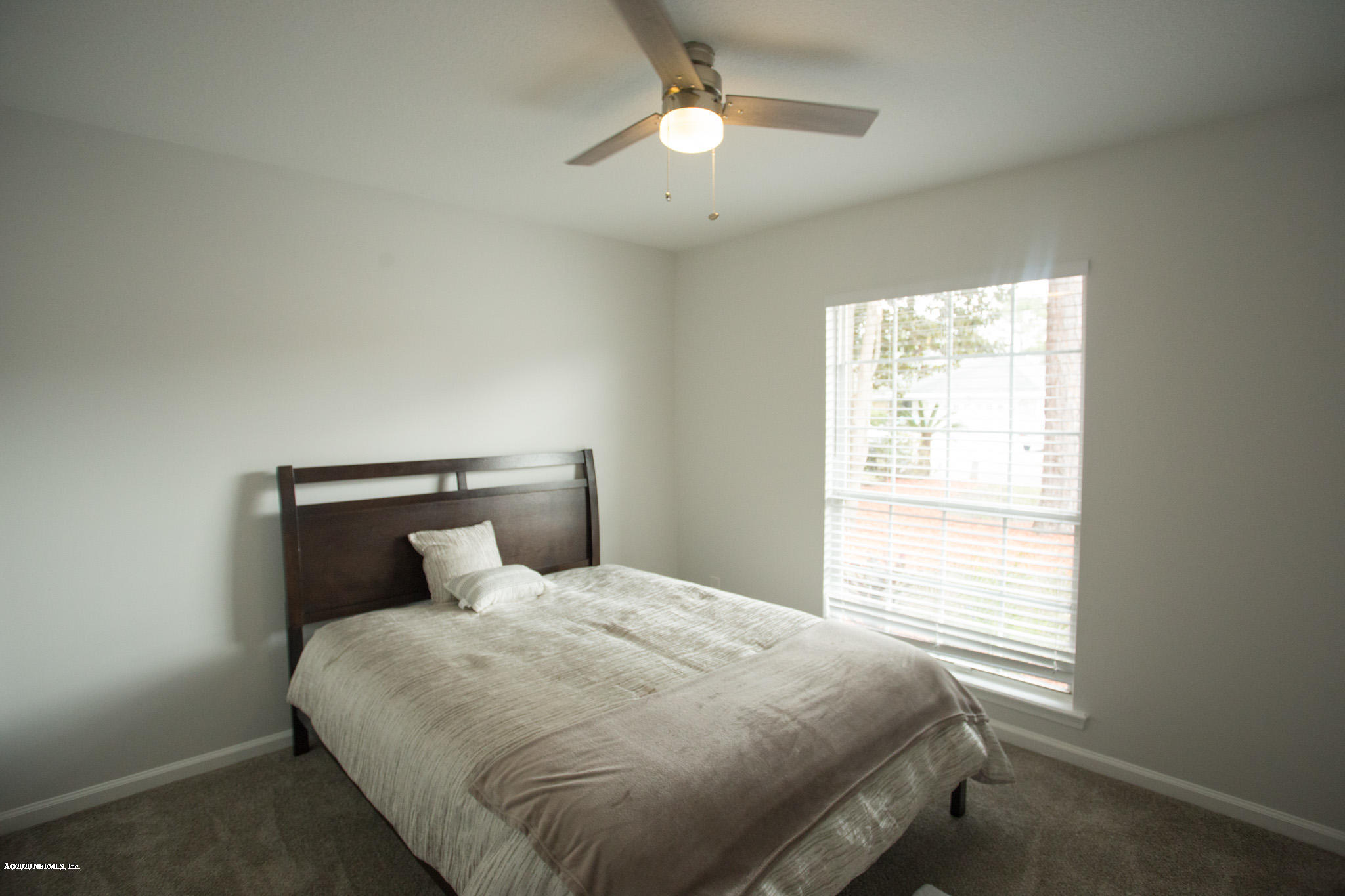 7864 Collins Ridge Boulevard Jacksonville, FL 32244 - Photo 4 of 32 a bedroom with a bed and window