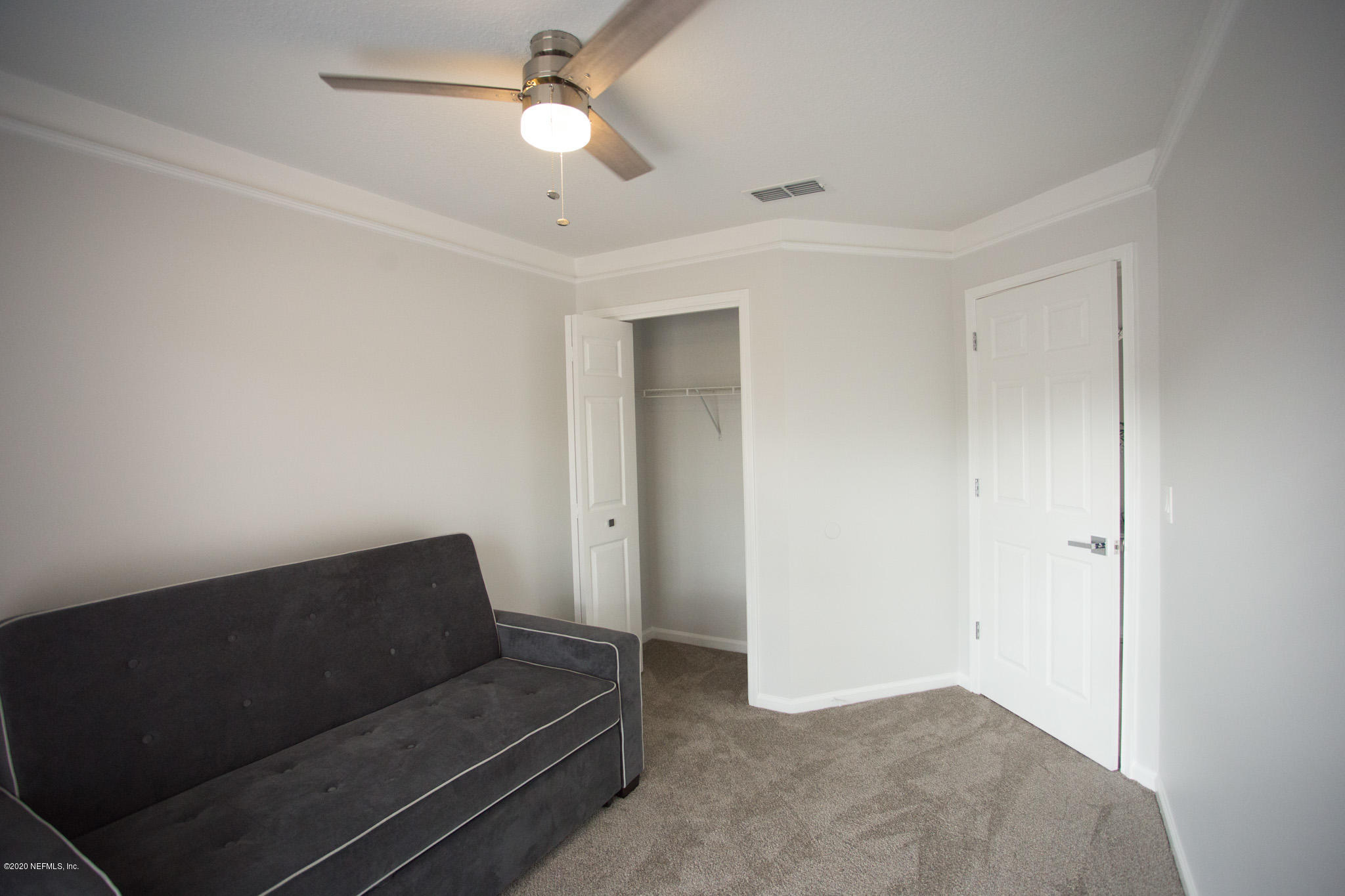 7864 Collins Ridge Boulevard Jacksonville, FL 32244 - Photo 5 of 32 a living room with furniture and a ceiling fan