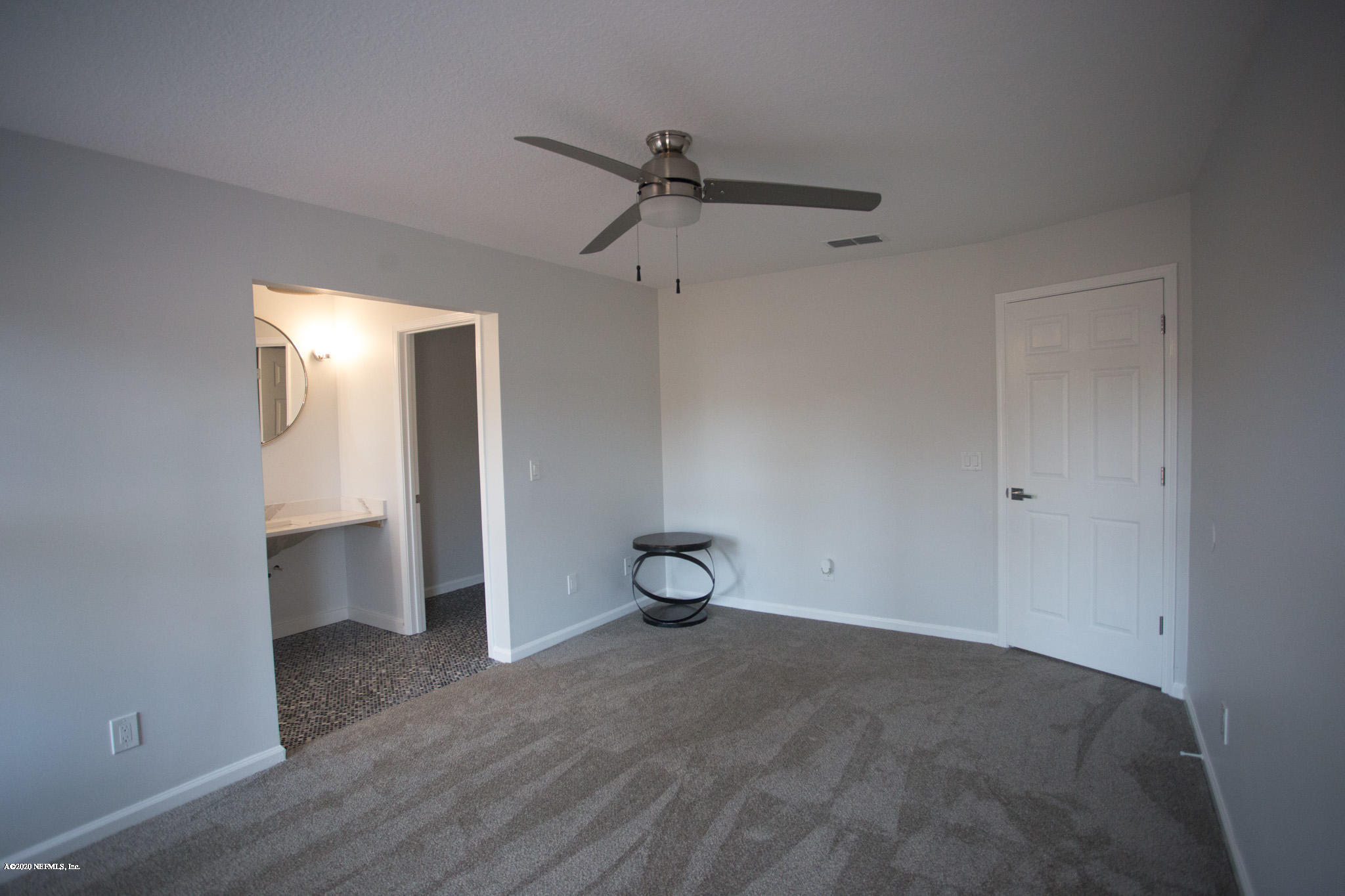 7864 Collins Ridge Boulevard Jacksonville, FL 32244 - Photo 8 of 32 a view of empty room with wooden floor and cabinet