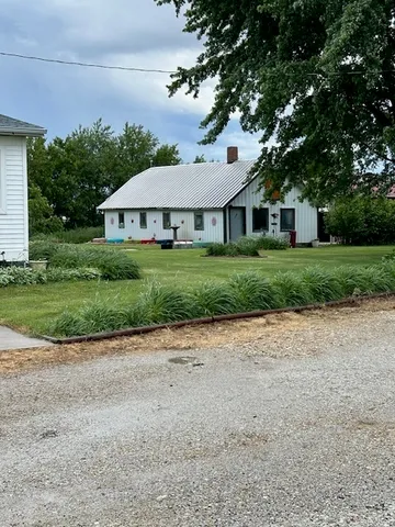 a front view of house with a garden