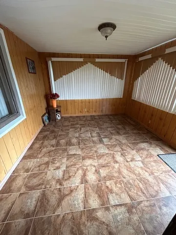 a kitchen with a table chairs and a refrigerator