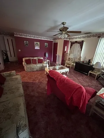 a bed sitting in a bedroom next to a cabinet