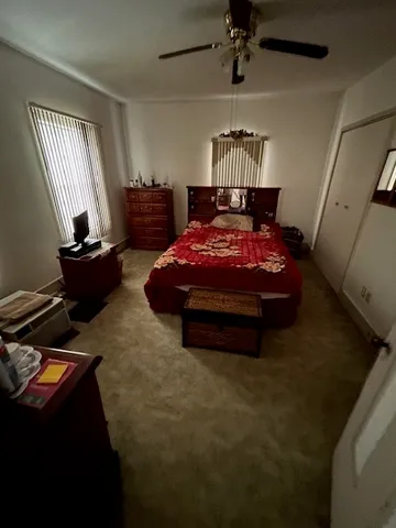 a bedroom with bed and window