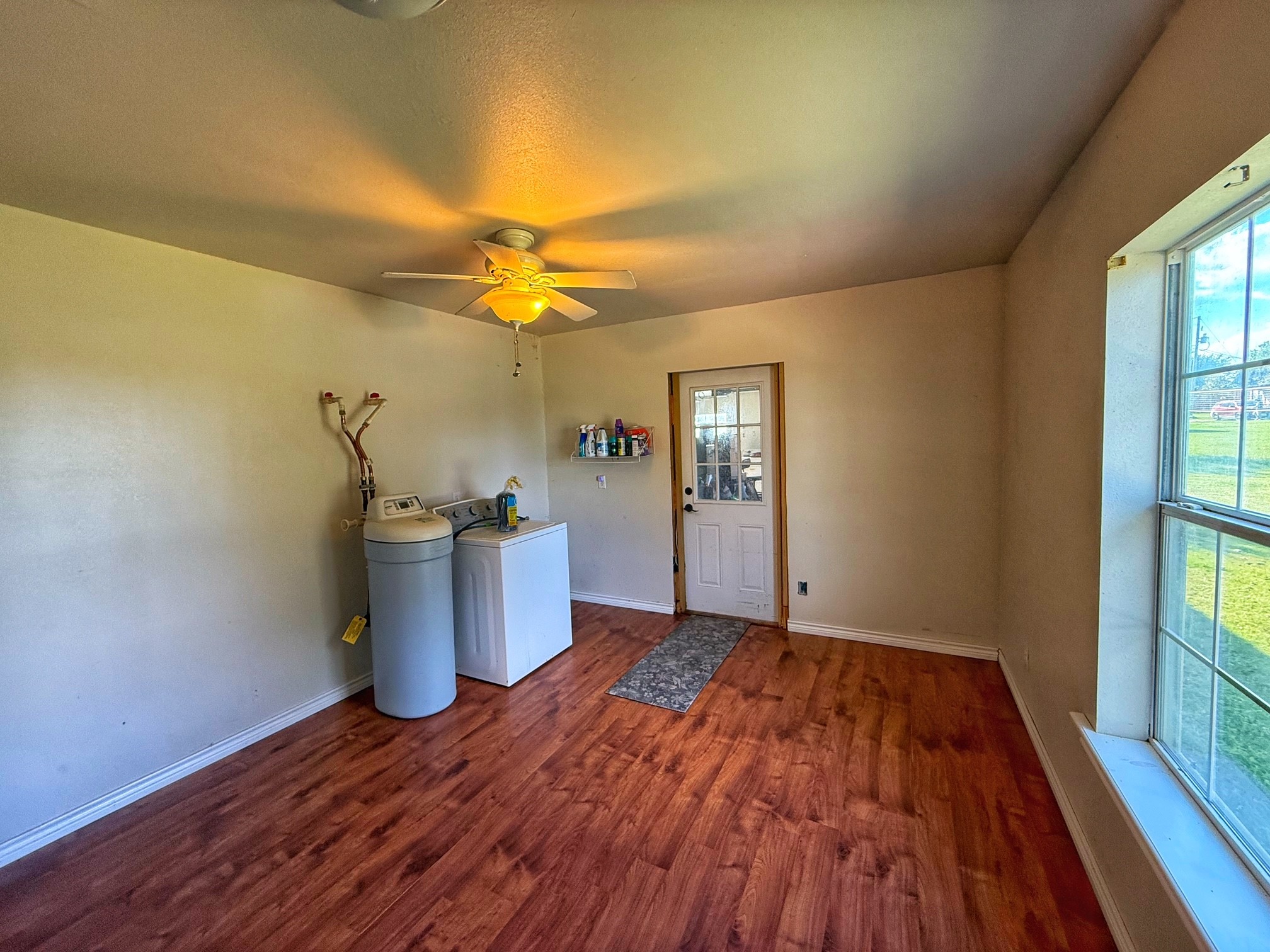 9496 Batson Road Normangee, TX 77871 - Photo 18 of 25 a view of a room with wooden floor and a window