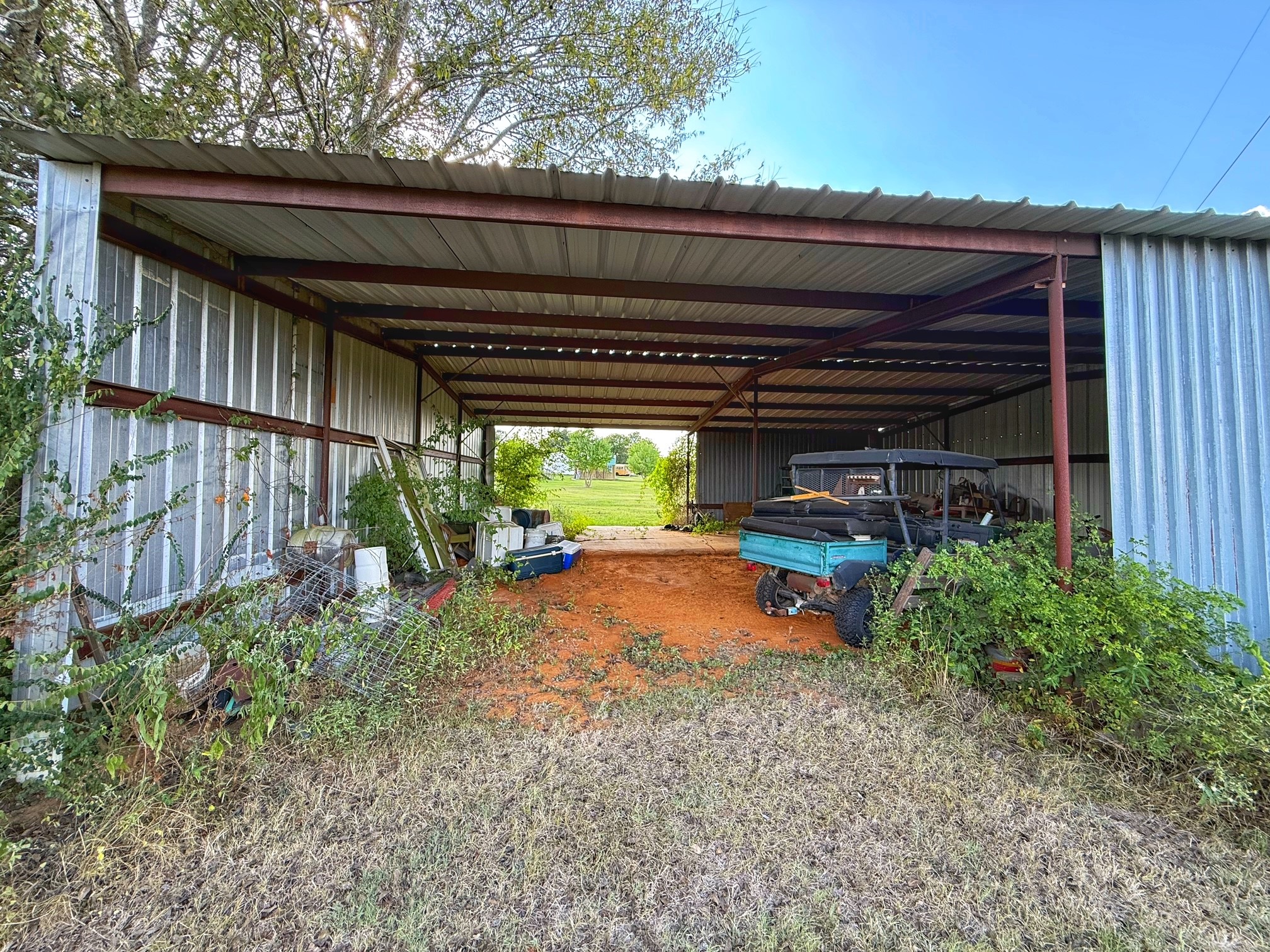 9496 Batson Road Normangee, TX 77871 - Photo 22 of 25 a view of a backyard with plants and a patio