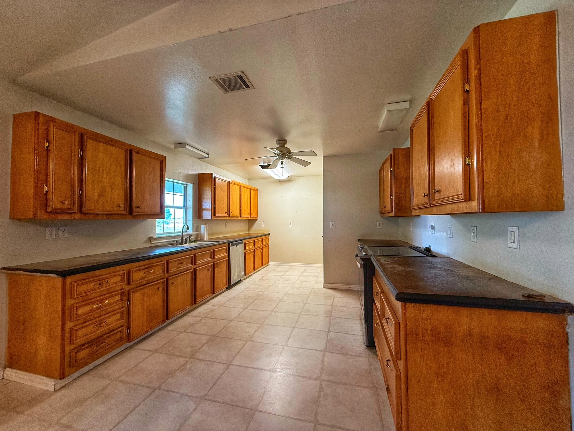 9496 Batson Road Normangee, TX 77871 - Photo 7 of 25 a kitchen with stainless steel appliances a sink stove and cabinets