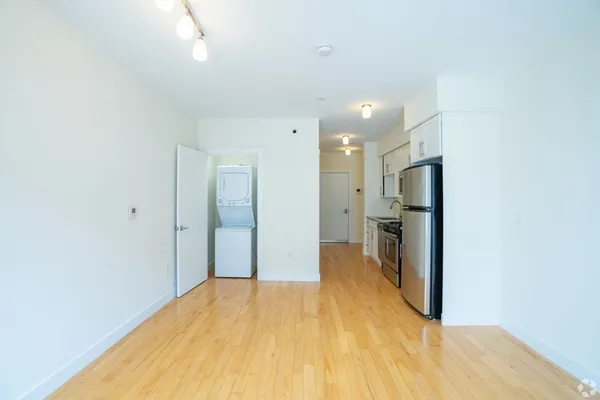 a view of a bathroom with a sink and a refrigerator