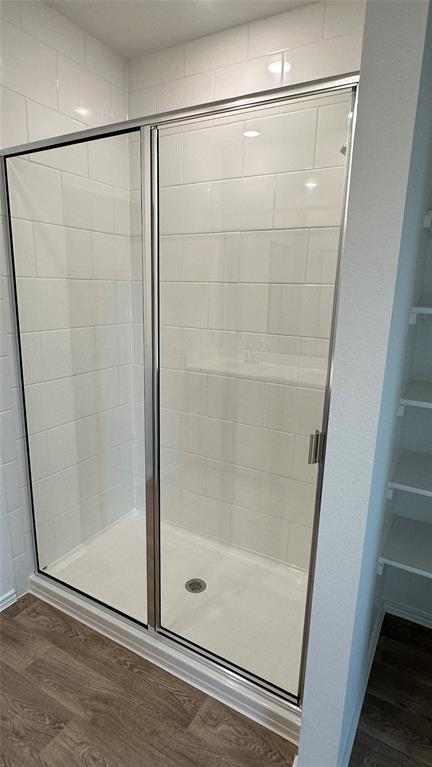204 Inks Lane Kyle, TX 78640 - Photo 12 of 25 Modern glass-enclosed shower featuring bright white tilework and recessed lighting.