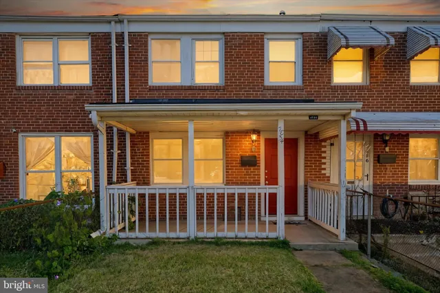 a view of a brick house with a small yard