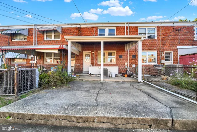 a front view of a residential apartment building with a yard