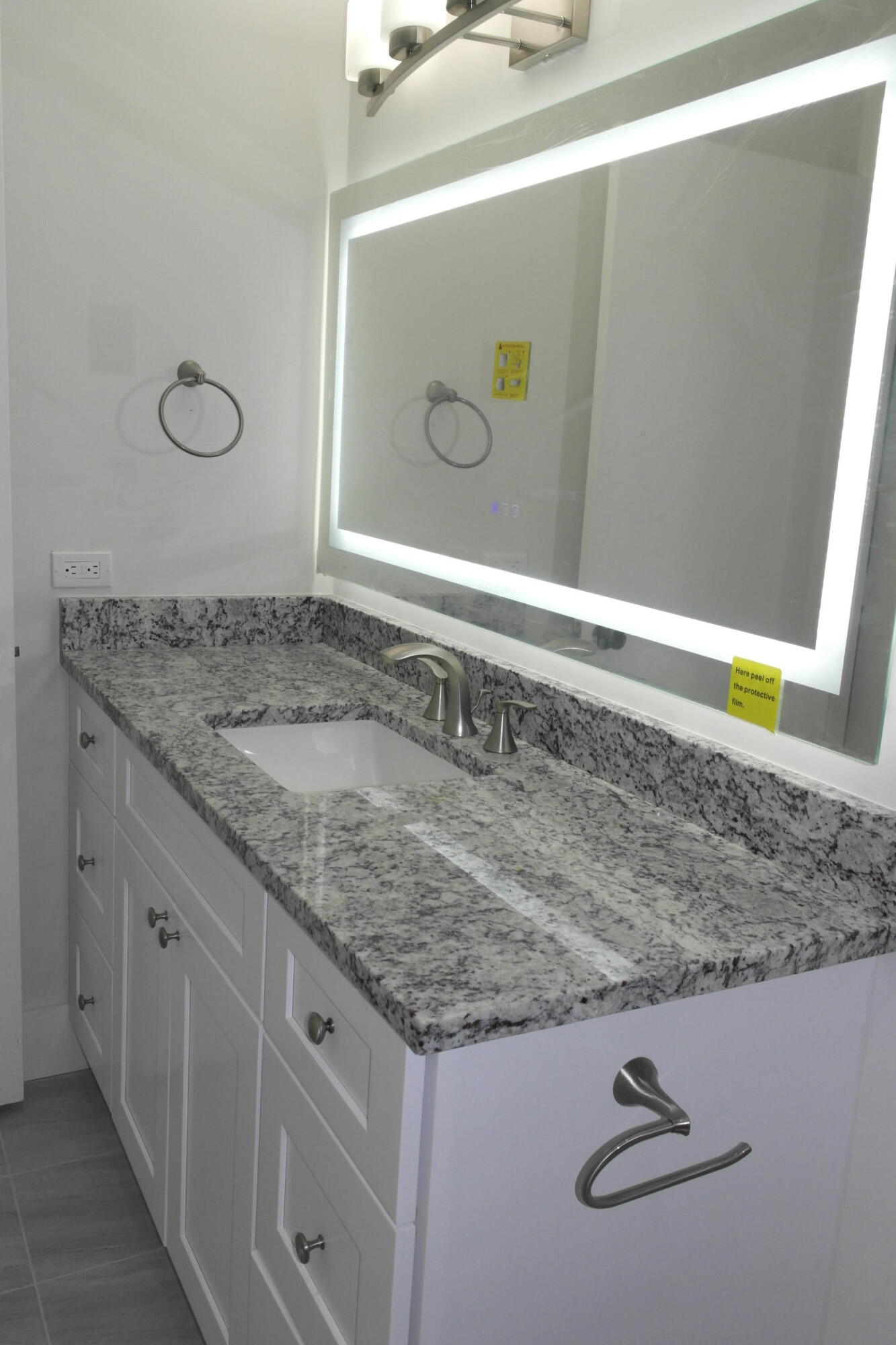 18890 Candlewick Drive, Unit B Boca Raton, FL 33496 - Photo 14 of 16 a bathroom with a granite countertop sink and a mirror