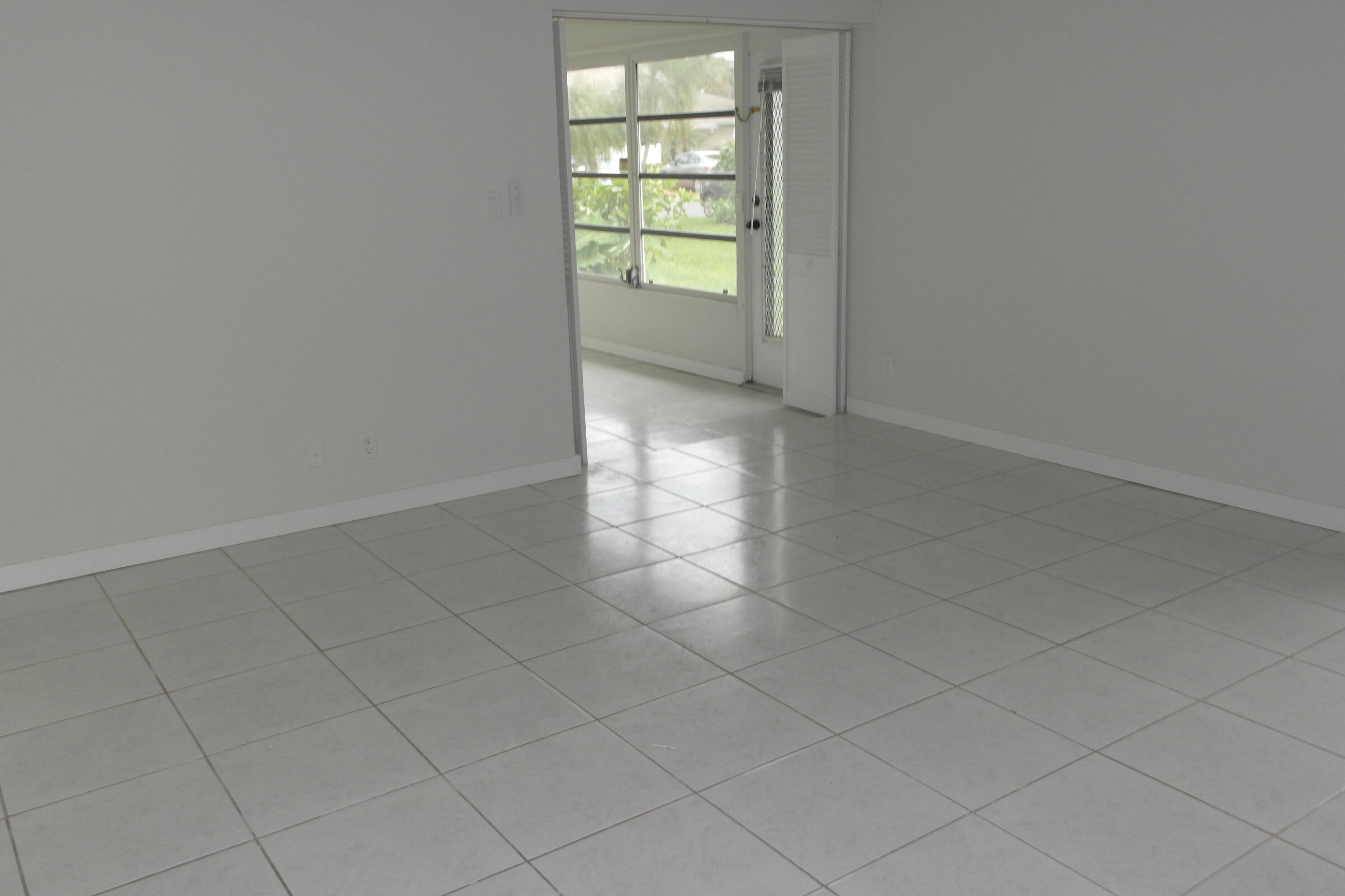 18890 Candlewick Drive, Unit B Boca Raton, FL 33496 - Photo 7 of 16 an empty room with windows