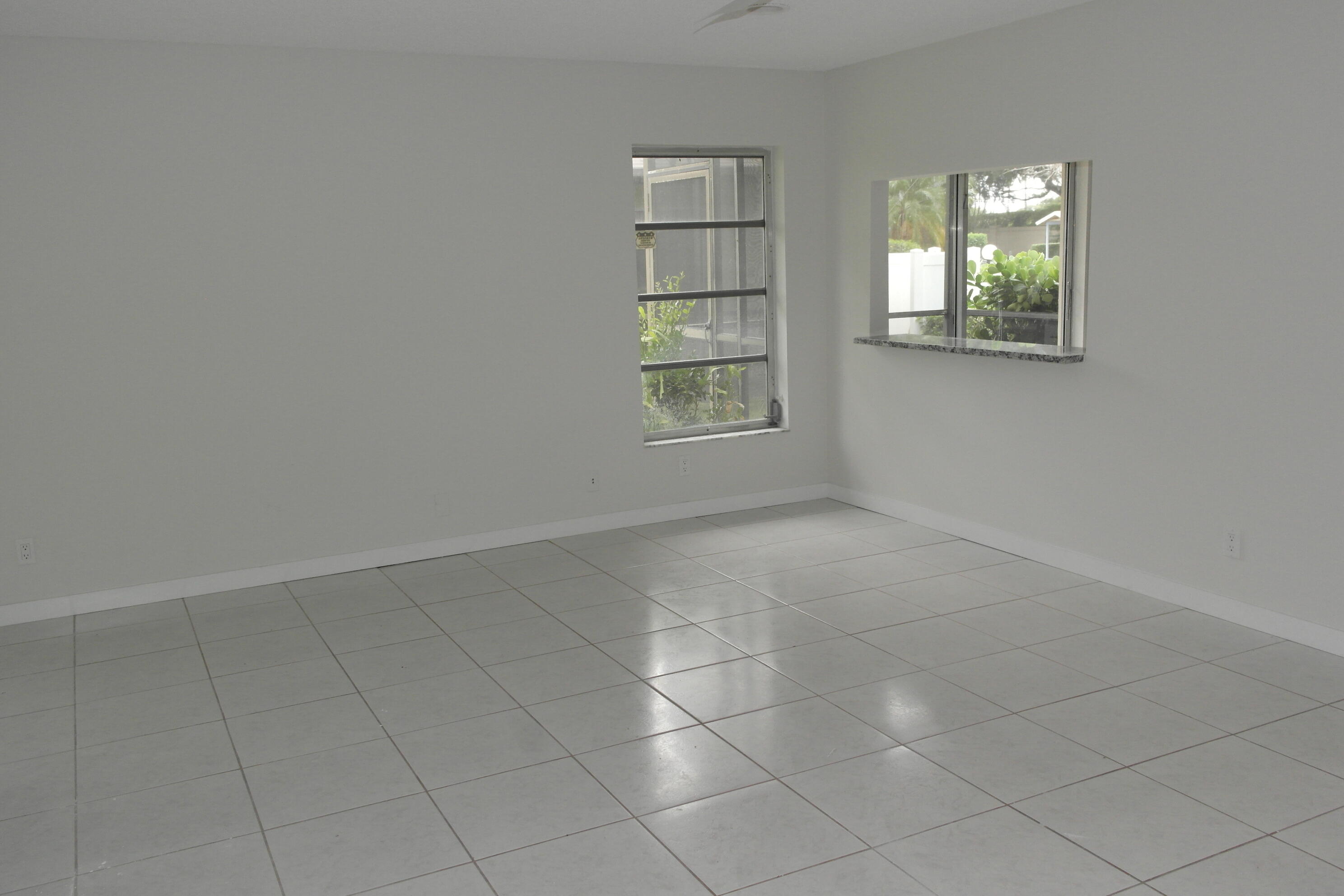 18890 Candlewick Drive, Unit B Boca Raton, FL 33496 - Photo 9 of 16 an empty room with windows and closet
